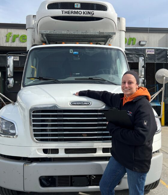 woman-standing-next-to-food-distributor-truck